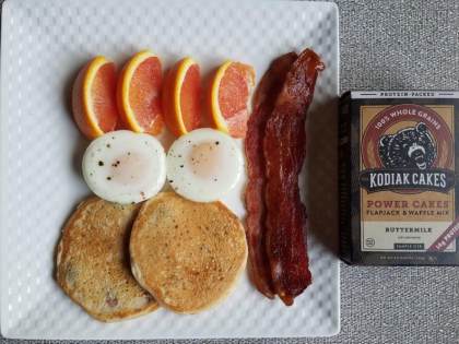 Kodiak Cakes Power Cakes with poached eggs, nitrate-free bacon and Cara Cara oranges.