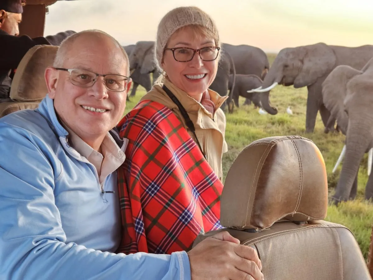 Maria Faires, RD in Amboseli with her husband in safari vehicle with elephant in background