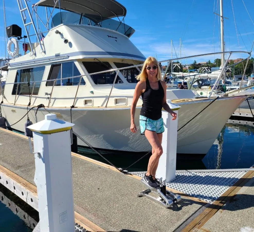picture of woman in front of a boat exercising on an Xiser Machine
