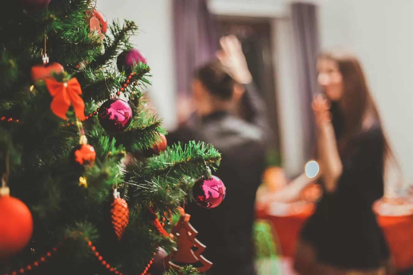 Christmas Tree and people in background at a party